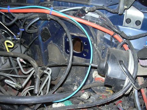 1991 Ford Bronco - Close-up view of brake lines and wiring within a vehicle's engine bay.
