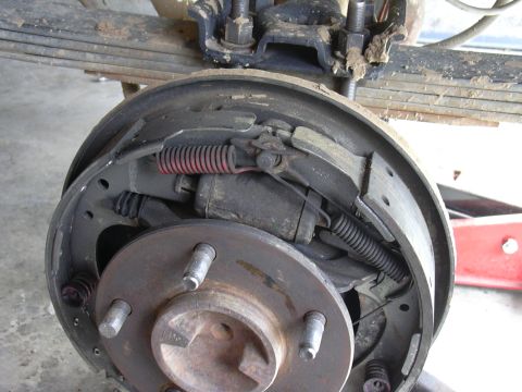 1991 Ford Bronco - Close-up of a vehicle's rear drum brake assembly, showing internal components.