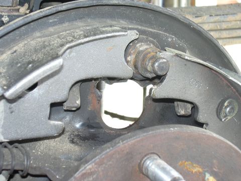 1991 Ford Bronco - Close-up of a vehicle's brake drum assembly, showing brake shoes and hardware.