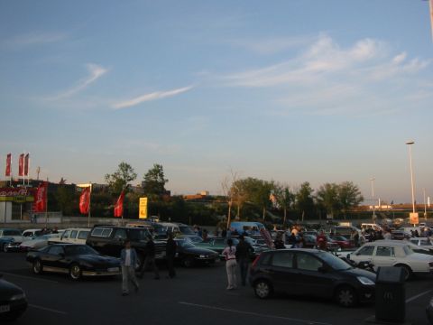 1992 Ford Crown Victoria - Cars and people gather in a parking lot during an outdoor event.