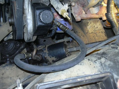 1991 Ford Bronco - Engine bay components including the power steering pump and fluid filter are visible in this close-up shot.