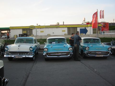 1992 Ford Crown Victoria - Three 1957 Chevrolet Bel Airs are displayed in a row at a car show.