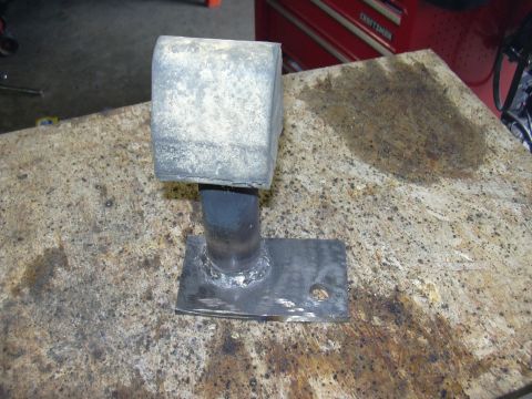 1991 Ford Bronco - A single rubber bump stop with a metal base is shown on a speckled workbench.