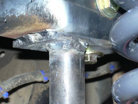1991 Ford Bronco - Close-up of a welded bracket and suspension components, likely part of an aftermarket modification.