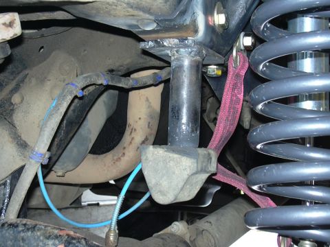 1991 Ford Bronco - Vehicle suspension components, including a coil spring and bracket, are visible in this close-up shot.