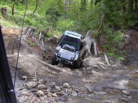 1991 Ford Bronco - A vehicle navigates a challenging off-road path with steep inclines and obstacles.