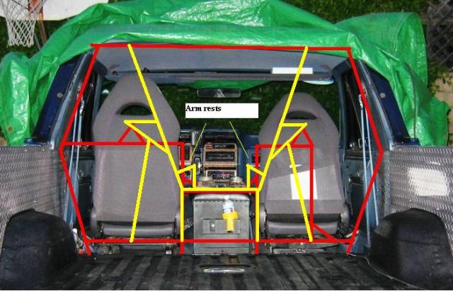 Vehicle interior from tailgate with red/yellow roll cage plan lines drawn over seats