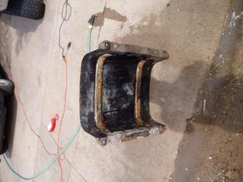 1990 Ford Bronco - A used fuel tank sits on a concrete surface, showing signs of rust around its edges.