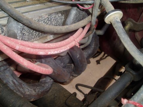 1990 Ford Bronco - This image shows engine components, specifically the exhaust manifold and spark plug wires, not the entire vehicle.