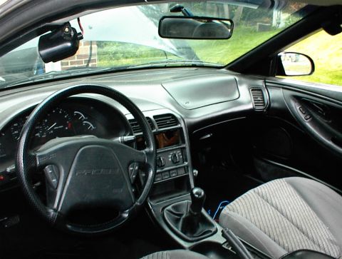 1994 Ford Probe - The interior of a 1994 Ford Probe, showing the dashboard and steering wheel with the model name clearly visible.