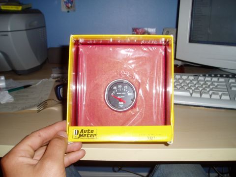 1990 Ford Bronco - An Auto Meter oil pressure gauge is shown in its original packaging.