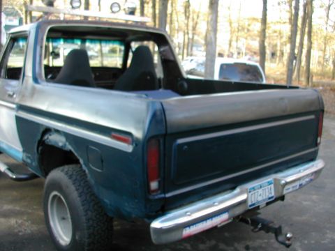 1979 Ford Bronco - Rear view of a Ford Bronco, likely a 1978 model, with a custom roof rack and interior modifications.