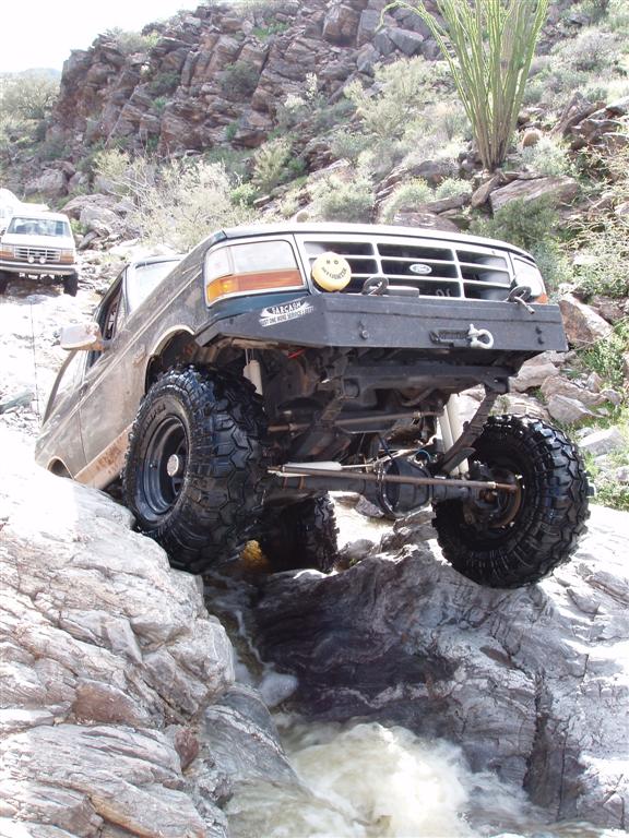 1994 Ford Bronco navigating rocky terrain with another Bronco behind it