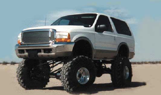 White SUV with custom grille and massive off-road tires, lifted suspension