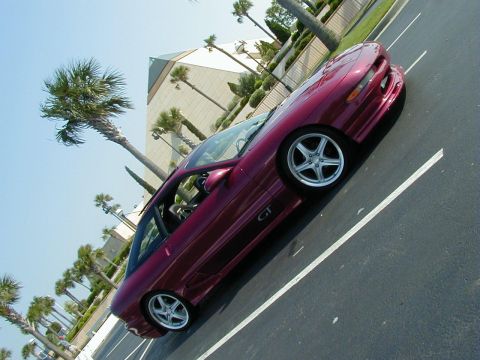 1994 Ford Probe - Maroon 1994 Ford Probe GT parked in a lot with palm trees and a pyramid-shaped building.