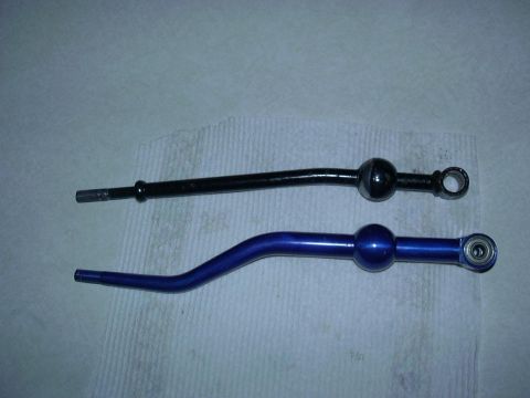 1995 Ford Probe - A black shifter lever is shown next to a blue shifter lever with a visible bearing.