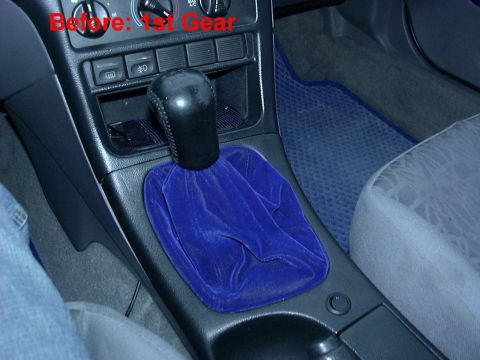 1995 Ford Probe - The interior of a vehicle shows a shifter console with a blue shift boot and text indicating 'Before: 1st Gear'.