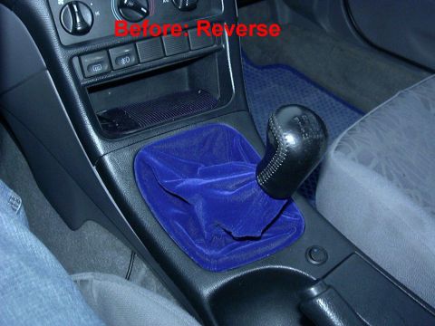 1995 Ford Probe - Interior view of a car's gear shifter with a blue velvet boot and a black leather knob.