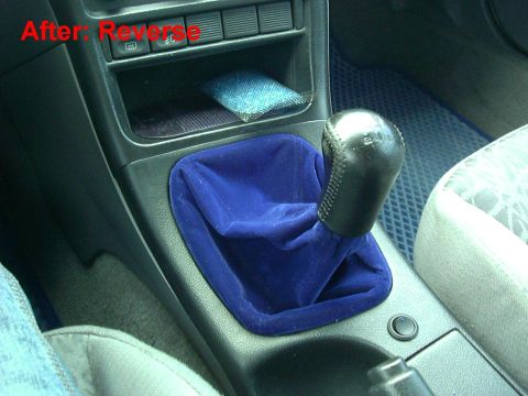 1995 Ford Probe - Interior view of a car's center console a blue velvet shifter boot and a leather shift knob.