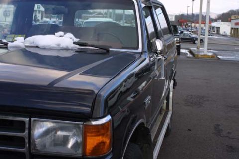 1989 Ford Bronco - This 1989 Ford Bronco is seen from a 3q-front angle with snow accumulated on its hood.