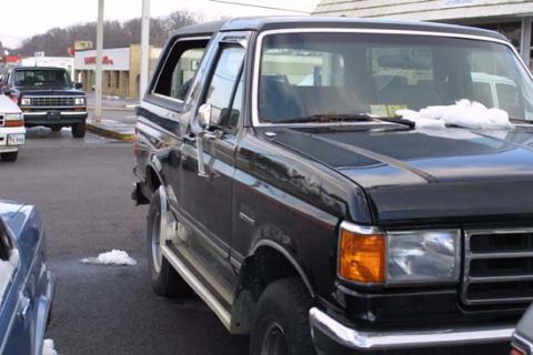 1989 Ford Bronco - Black 1989 Ford Bronco parked in a lot with snow on the ground.