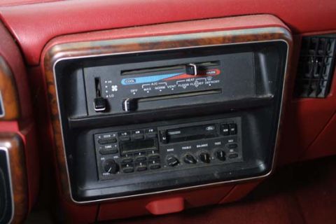 1989 Ford Bronco - The interior of a 1989 Ford Bronco displays its dashboard with climate controls and a Ford-branded radio.