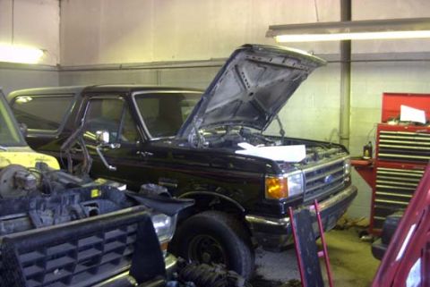 1989 Ford Bronco - Thank God I found a shop that wants to work for a living! Inside the shop, hood is up, thats progress compared to the previous shop!