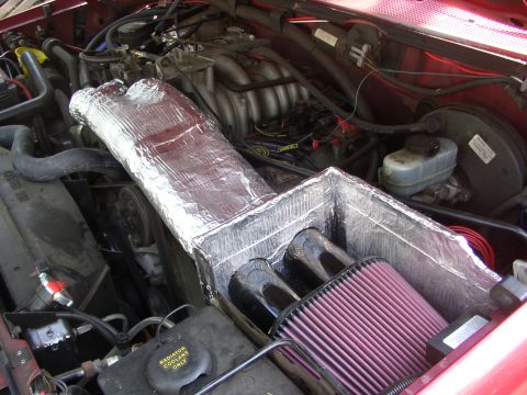 1995 Ford Bronco - Engine bay view of a custom K&N intake system with dual intake tubes and a conical air filter.