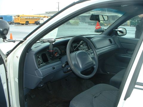 1999 Ford Crown Victoria - Interior view of a 1999 Ford Crown Victoria police car, the dashboard and driver's seat.