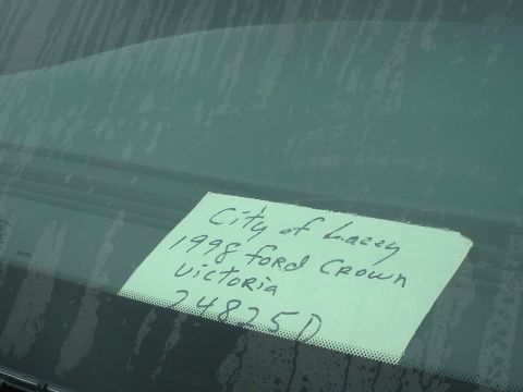 1999 Ford Crown Victoria - A handwritten note on a windshield details vehicle information, including the year and model.