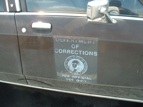 1999 Ford Crown Victoria - This vehicle door displays official markings from the Department of Corrections, indicating its former use.