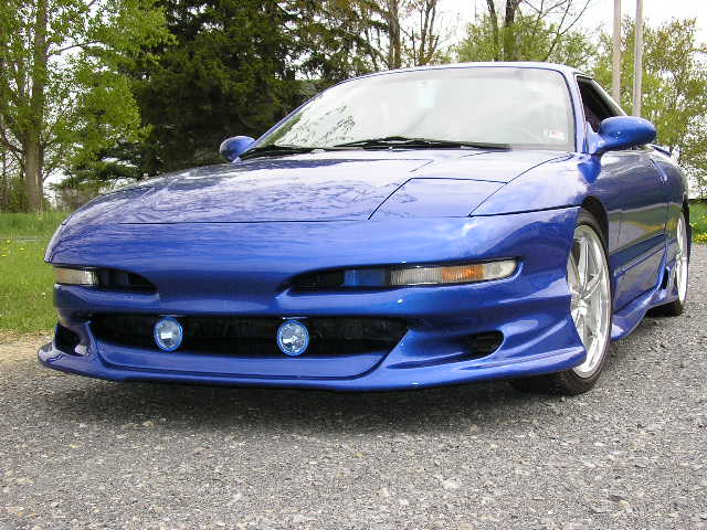 Blue 1994 Ford Probe front view with custom body kit and fog lights