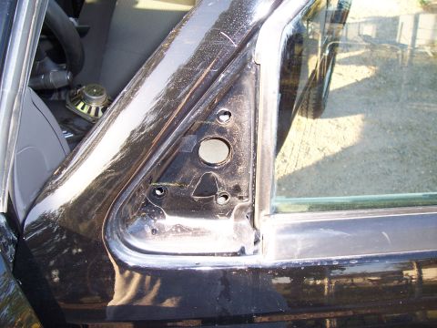 2003 Ford Ranger - Close-up view of the interior door frame, revealing mounting points and a speaker.
