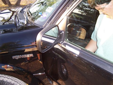 2003 Ford Ranger - The 'Ranger' badge is visible on the fender of this black pickup truck.