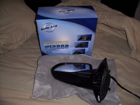 2003 Ford Ranger - A replacement side mirror is shown next to its KOOL-VUE packaging, which indicates it is an original equipment style mirror.