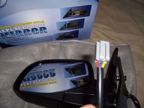 2003 Ford Ranger - A new side mirror is shown with its packaging, which details its features and installation.