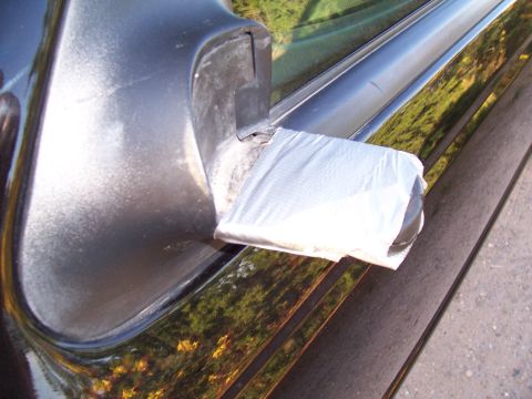 2003 Ford Ranger - A black door handle is repaired with silver duct tape.