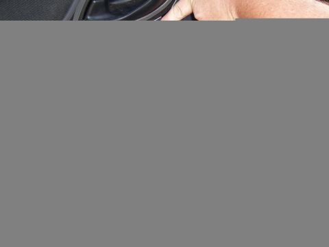 2003 Ford Ranger - A hand is shown touching the black grille of a speaker.