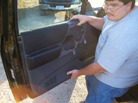 2003 Ford Ranger - Man removing the interior door panel of a 2003 Ford Ranger.