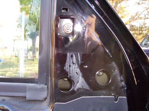 2003 Ford Ranger - Close-up view of the interior of a vehicle's door panel, revealing internal components.
