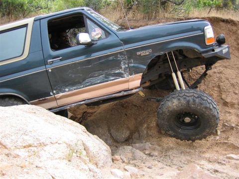1994 Ford Bronco - This heavily modified Ford Bronco navigates a challenging rocky terrain.
