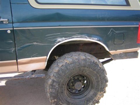 1994 Ford Bronco - This 1994 Ford Bronco's rear quarter panel has extensive damage from off-roading or an accident.