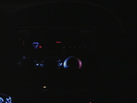 1999 Ford Taurus - Illuminated climate controls and digital display in a car's interior.