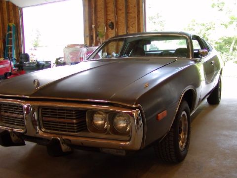 1988 Ford Bronco - This 1973 Dodge Charger is parked inside a garage with the door open.