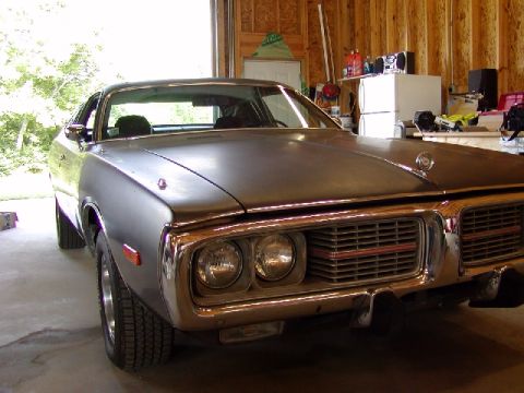 1988 Ford Bronco - Front view of a 1971-1974 Dodge Charger parked inside a garage.