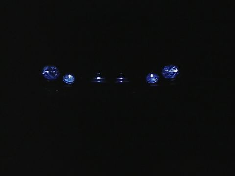 1999 Ford Taurus - Close-up of blue lights on a dark surface, with Supermotors.net watermark visible.