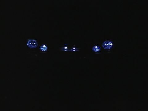 1999 Ford Taurus - Headlights are visible in the dark, but the vehicle is not identifiable.
