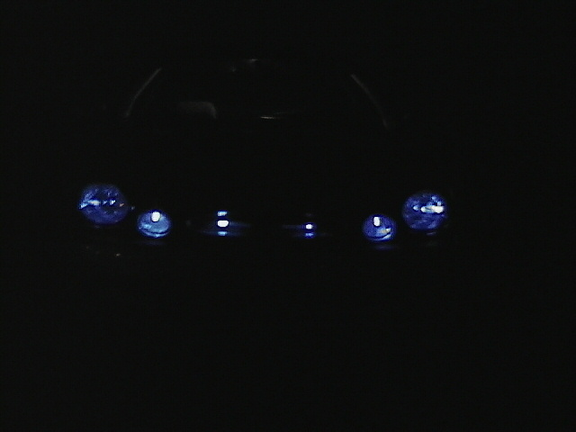 Two headlights on a dark background
