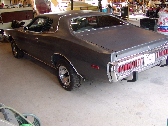 1973 Dodge Charger rear view, dark color, chrome bumper, trailer hitch