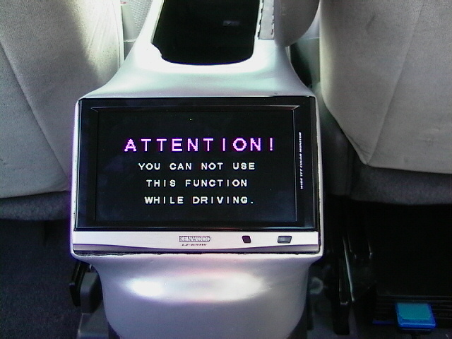 Digital display screen with text 'ATTENTION OK' and other lines of text